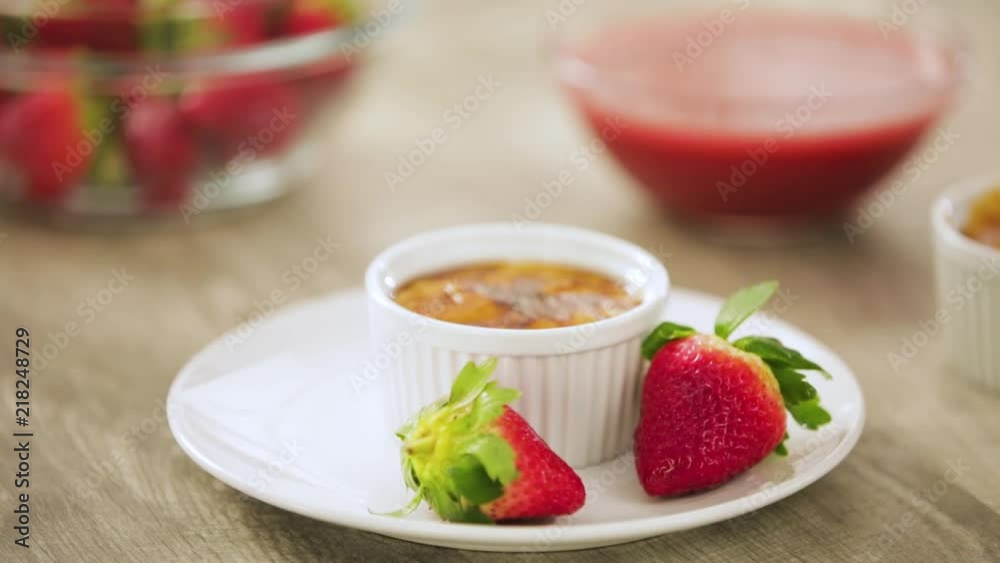 Placing Strawberries on Plate with Creme Brulee Placing Strawberries on Plate with Creme Brulee