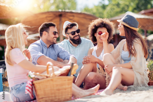 Group of friends having fun on the beach