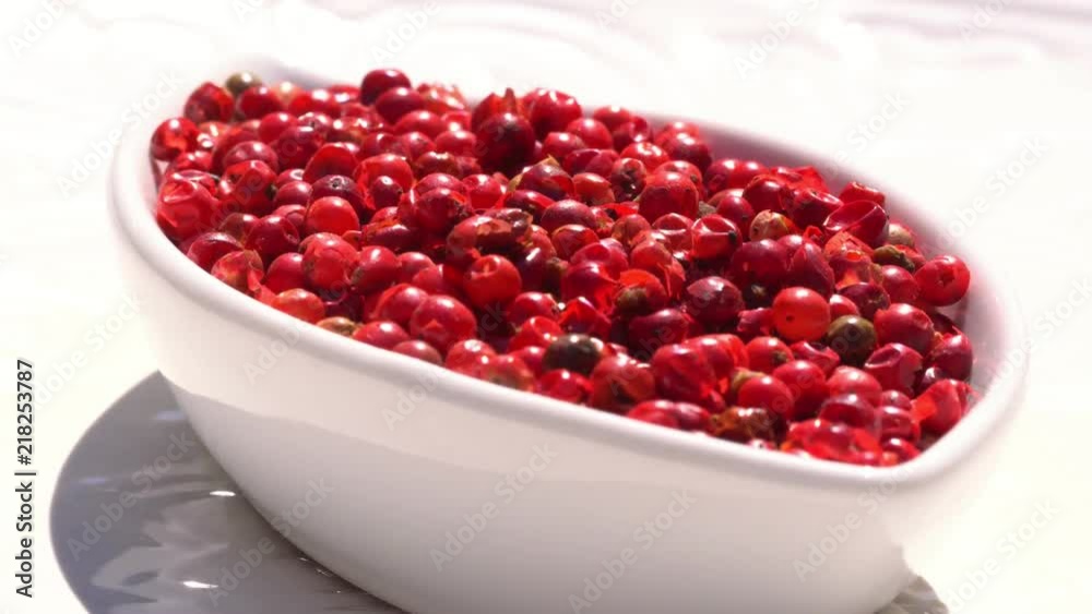 Dry spices pink pepper on a rotary table. 4K. Macroshooting.