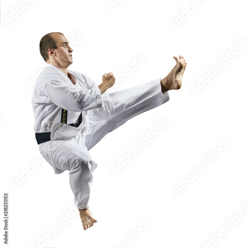 Kicking forward in a jump in the performance of an athlete in karategi Kaderov