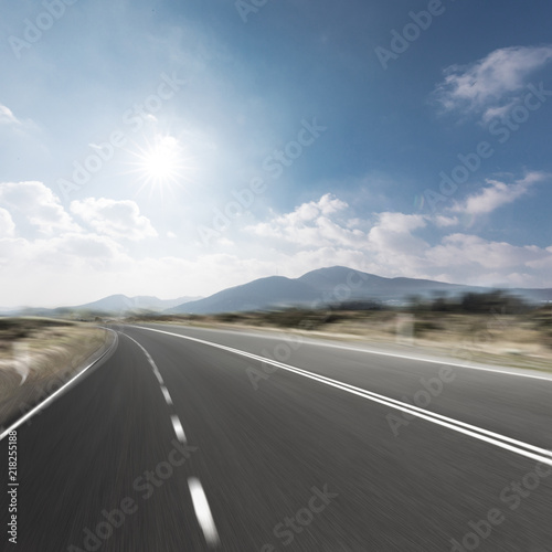 highway through mountain with blue sky