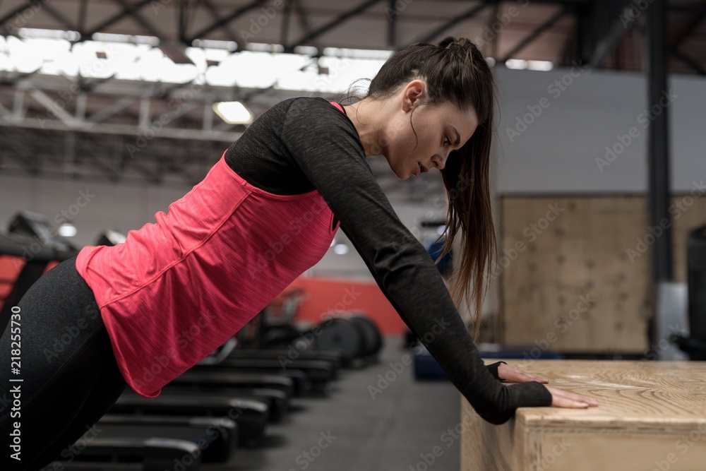 Woman doing push up exercise in fitness studio