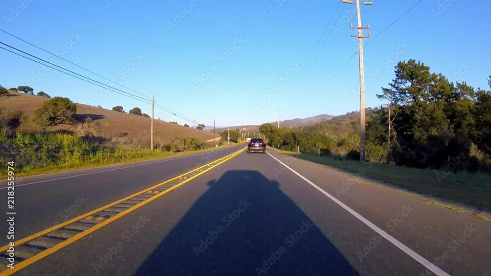 Driving down highway with only shadow of car being seen Driving down highway with only shadow of car being seen