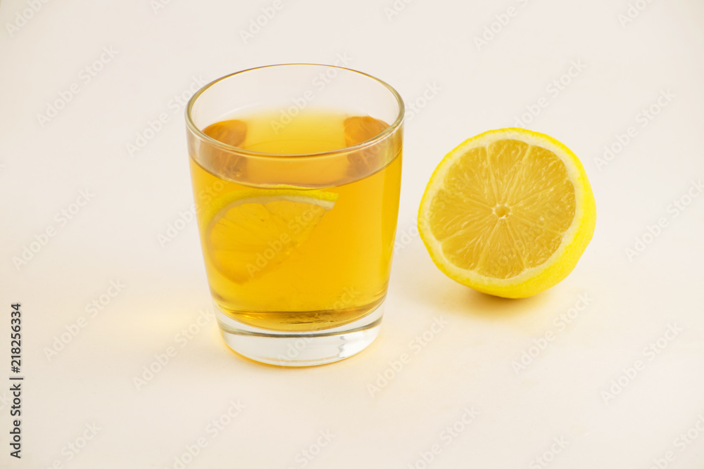 Cup of hot tea with lemon slice on a white background. Glass of ice tea with lemon. Healthy lifestyle. Cup of hot tea with lemon slice on a white background. Glass of ice tea with lemon. Healthy lifestyle.