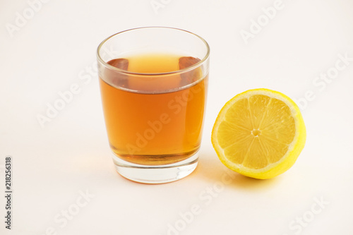 Cup of hot tea with lemon slice on a white background. Glass of ice tea with lemon. Healthy lifestyle.