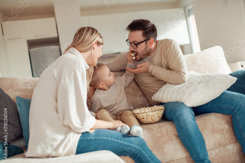 Young family watching movie together © ivanko80