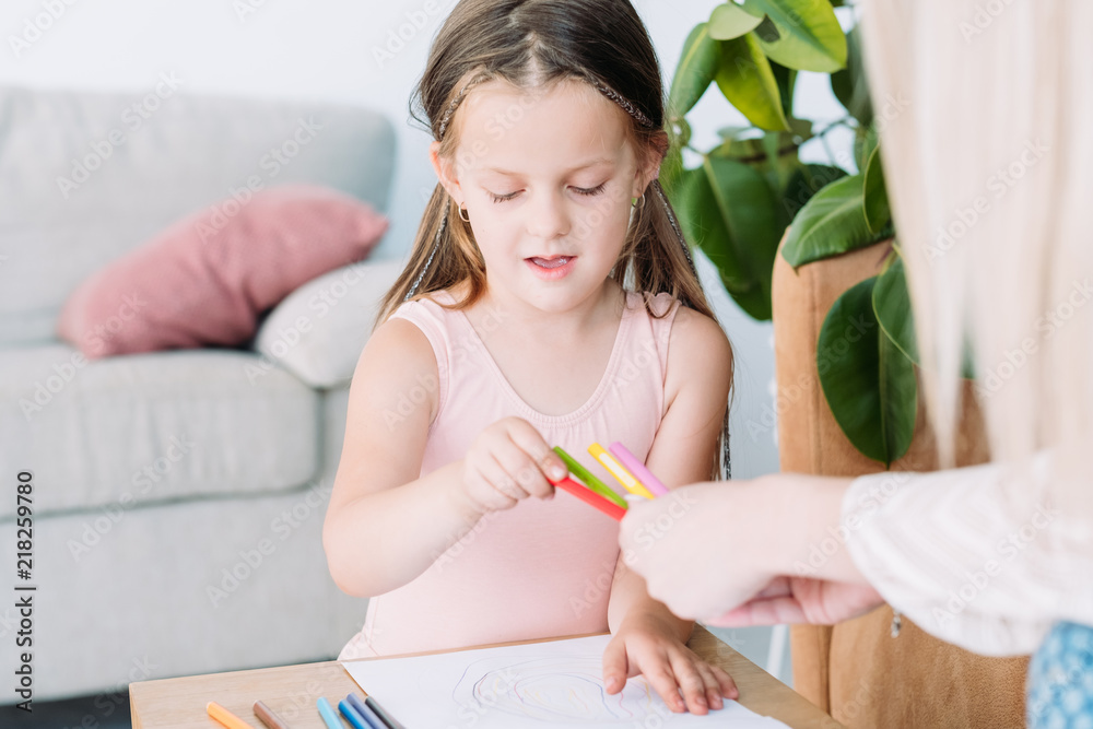 child drawing hobby. artful kids leisure. little girl choosing a pencil to express her imagination on paper. child drawing hobby. artful kids leisure. little girl choosing a pencil to express her imagination on paper.