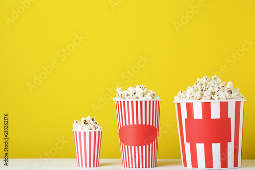 Popcorn in striped buckets on yellow background