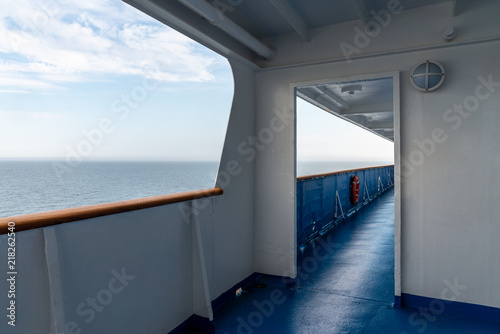 Perspective view of outdoor steel deck at a cruise ship with sea and horizon in the background. Horizontal view. © Pebo