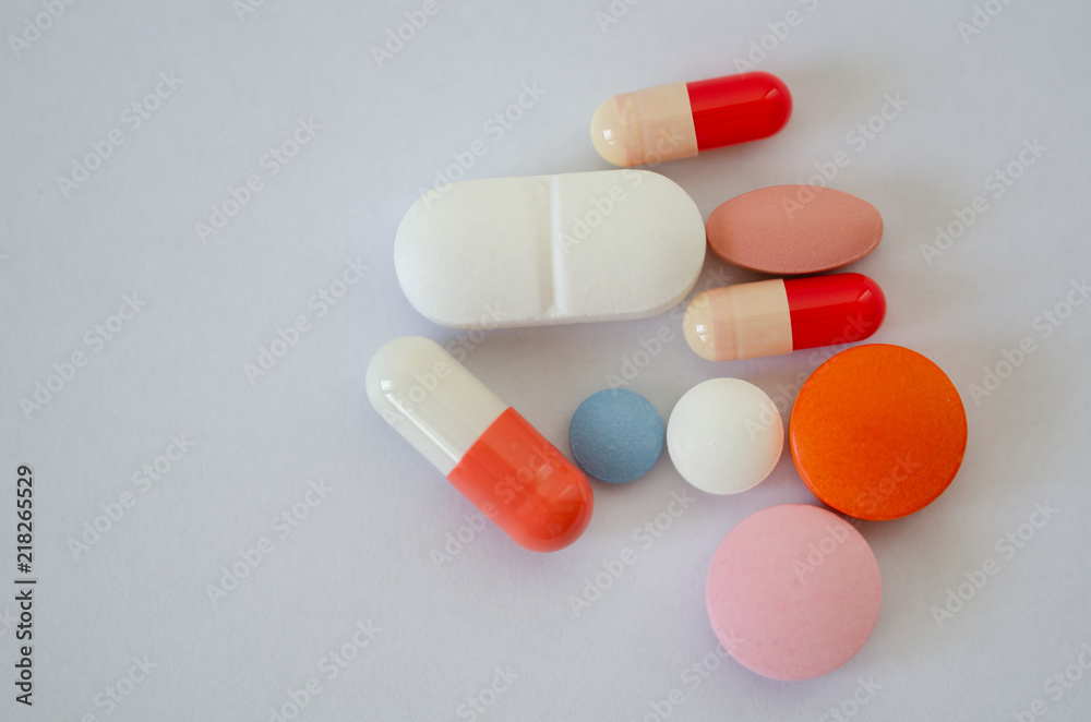Many different colors pills and tablets isolated on white background Many different colors pills and tablets isolated on white background