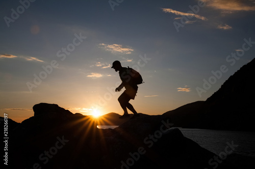Wallpaper Mural Man jumping on cliffs in sunset Torontodigital.ca