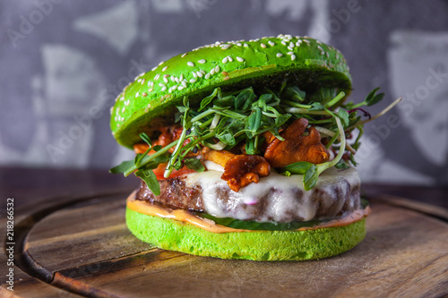 green burger with meat, cheese and mushrooms