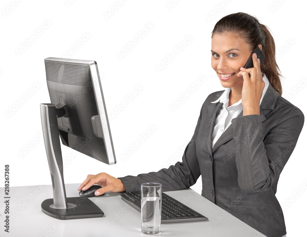 Portrait of a Businesswoman Talking on the Phone while Using Portrait of a Businesswoman Talking on the Phone while Using