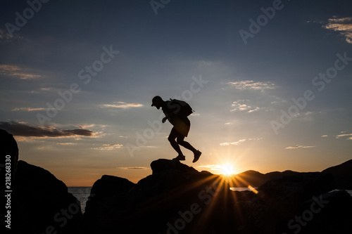 Wallpaper Mural Man jumping on cliffs in sunset Torontodigital.ca