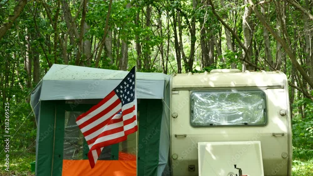 4k. American flag in caravan ,trailer camping in wood. 4k. American flag in caravan ,trailer camping in wood.