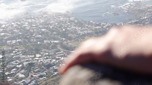 Camps Bay Neighbourhood of Cape Town, South Africa detailed view from distance with a hand on the rocks