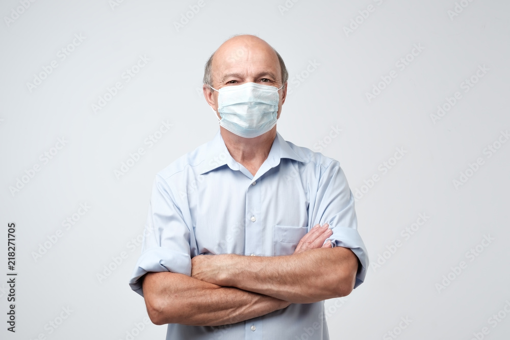 portrait of serious man in special medic mask. He is looking serious. Mature experienced doctor. portrait of serious man in special medic mask. He is looking serious. Mature experienced doctor.