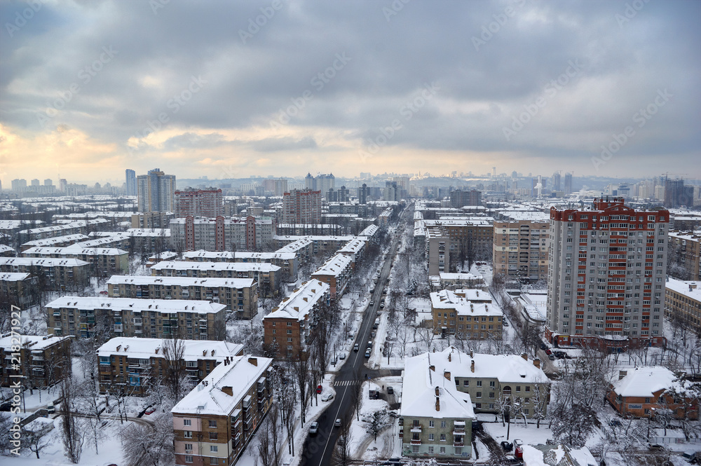 The aerial View of residential district in Kyiv,Ukraine in cloudy winter day.View over the city rooftops with sunlight and snow.Moderns buildings at Industrial uptown, residential neighbourhood The aerial View of residential district in Kyiv,Ukraine in cloudy winter day.View over the city rooftops with sunlight and snow.Moderns buildings at Industrial uptown, residential neighbourhood