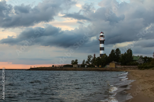 Lighthouse at the entrance to the port of Riga in the evening, in August