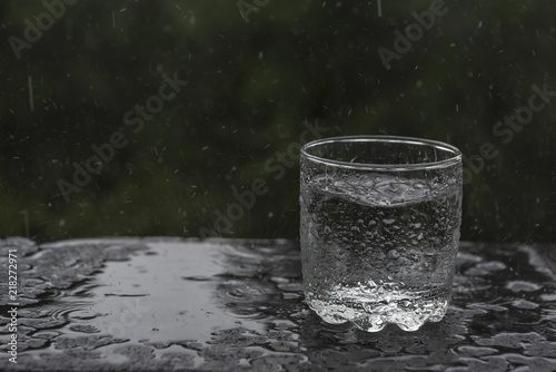 Summer rain filling a glass with water