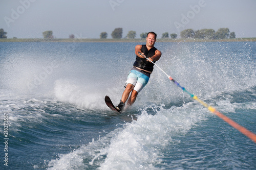 A slalom waterskier on a sunny morning. photo