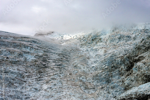 Climbing up Franz Josef Glacier in to the clouds