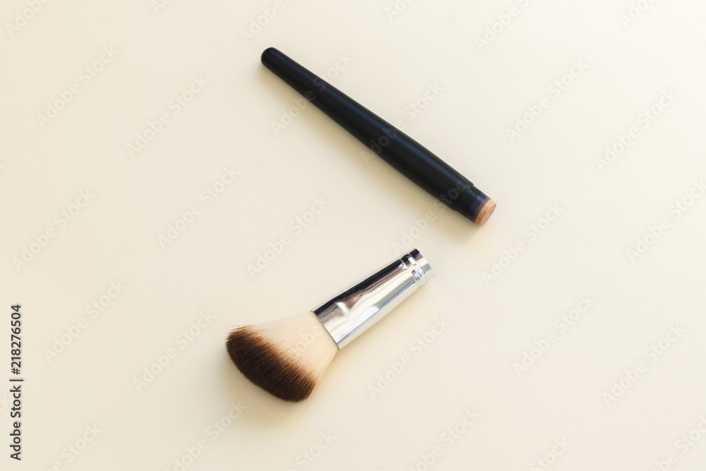 Broken cosmetic brush on a light background Broken cosmetic brush on a light background