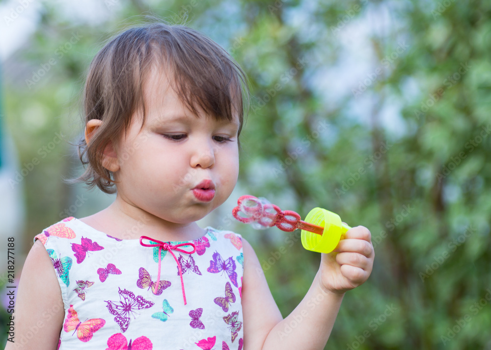 Cute little girl is blowing a soap bubbles. Cute little girl is blowing a soap bubbles.