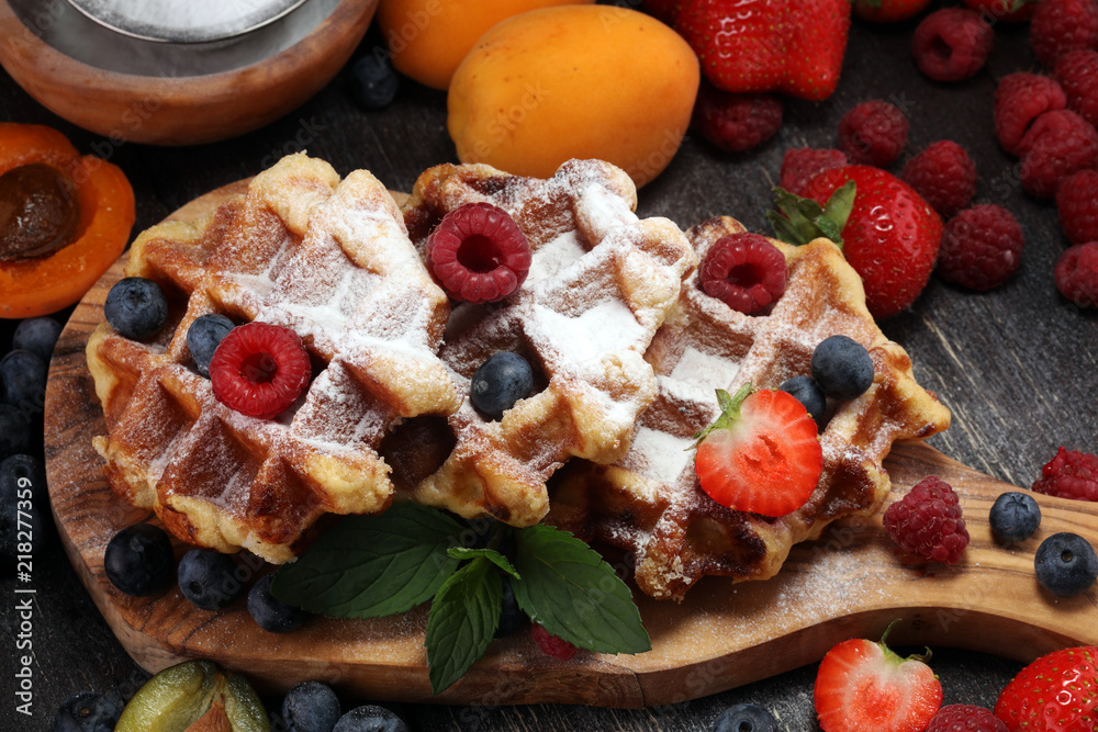 Traditional belgian waffles with fresh mint, sugar and raspberries.