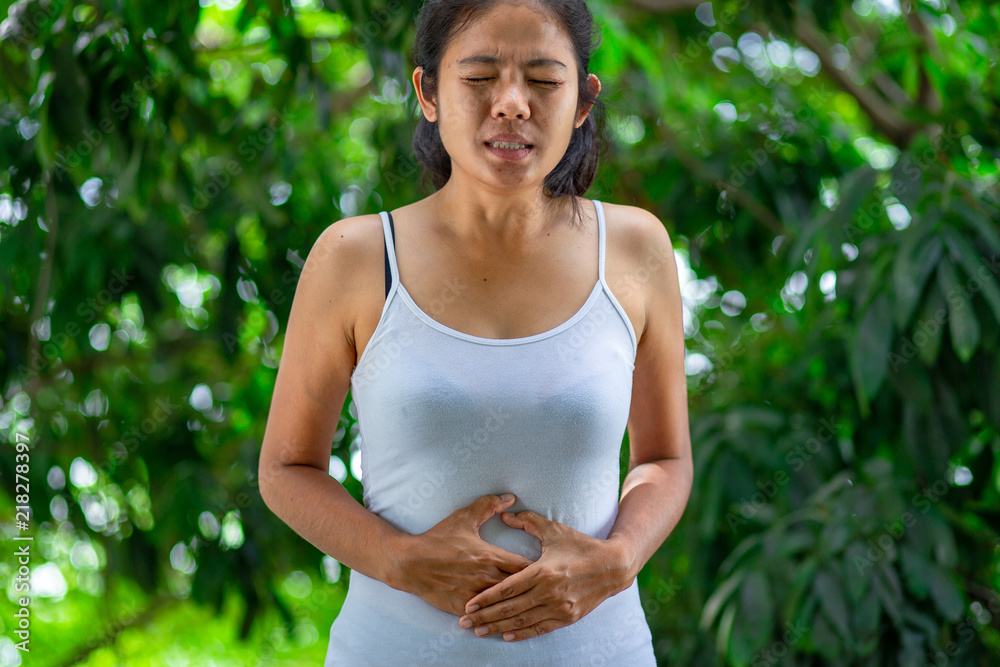Young woman having painful stomach ache.Chronic gastritis. Abdomen bloating concept. Young woman having painful stomach ache.Chronic gastritis. Abdomen bloating concept.