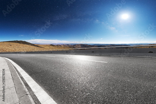 highway through mountain with blue sky