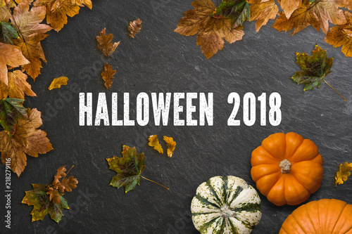 Schiefertafel mit Aufschrift "Halloween 2018" und herbstlicher Dekoration