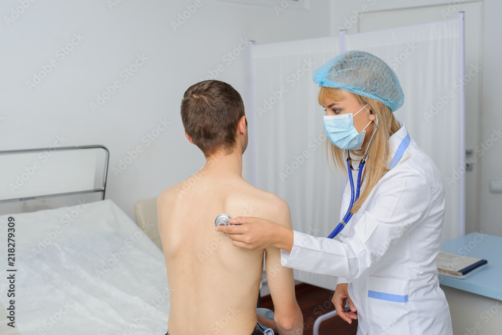 The doctor is consulting the patient with ultrascope at his back The doctor is consulting the patient with ultrascope at his back