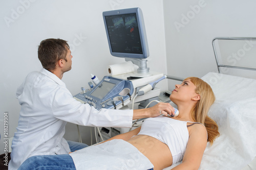The lady pacient at ultrasonography examination at the neck
