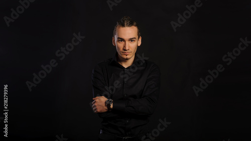 The handsome caucasian young man in a black shirt © Med Photo Studio