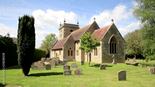 Old church and graves in English village churchyard