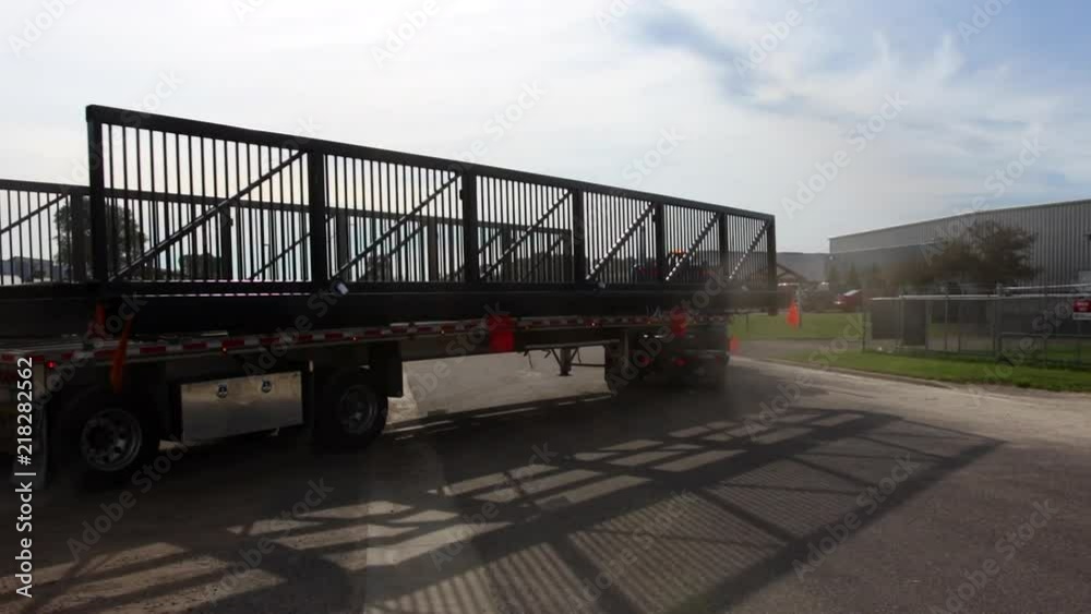 A semi with an oversized load pulls out with an escort behind. A semi with an oversized load pulls out with an escort behind.