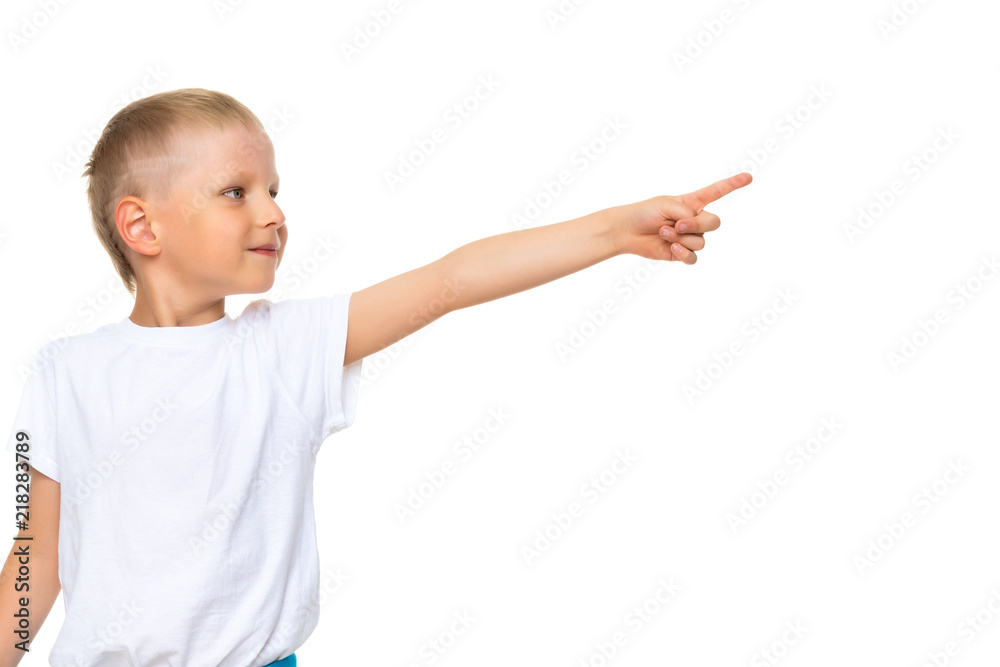 A little boy in a pure white T-shirt is pointing at something.