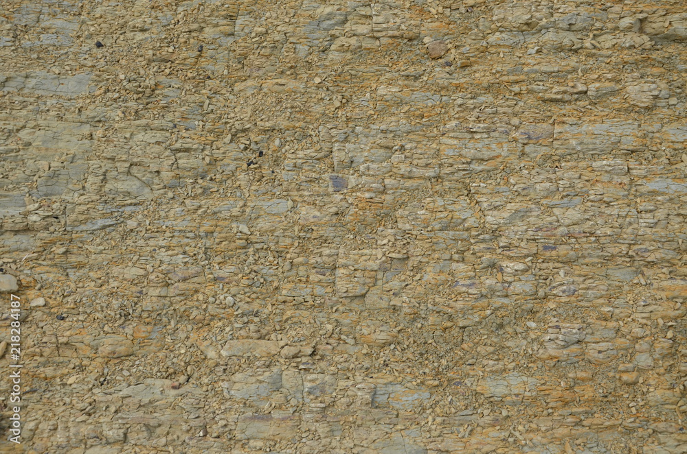 Natural rock structure background or texture. Lined rock with different natural colors. Natural rock structure background or texture. Lined rock with different natural colors.