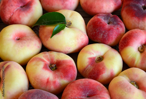 Chinese flat donut peaches also known as  Saturn donut, Doughnut peach,Paraguayo as a background.Healthy eating or diet concept.Selective focus. photo