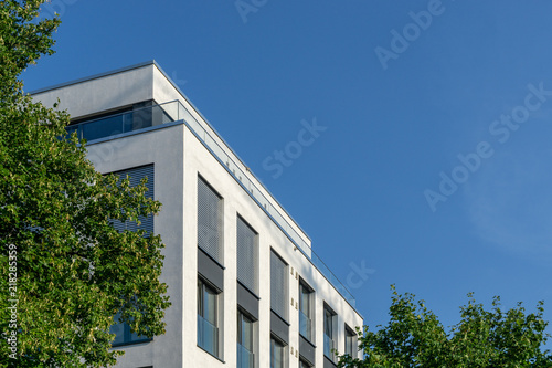 modern building surrounded by trees - copy space in the right upper corner © tl6781