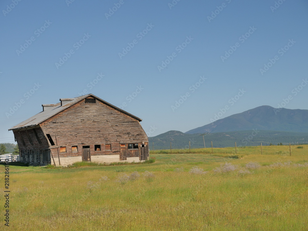 old leaning barn in field old leaning barn in field