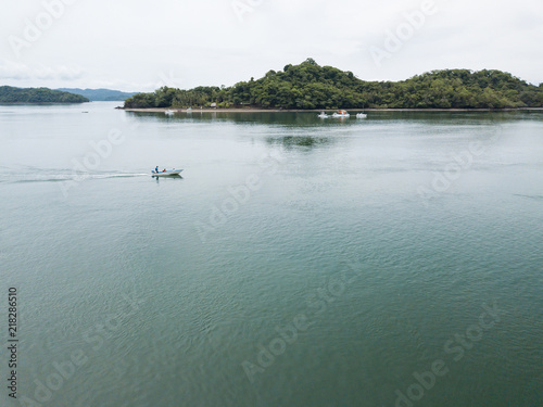 Wallpaper Mural A small motor boat with local fishermen leaves the protected small harbor as they head out into the Gulf of Nicoya Costa Rica in this aerial drone image Torontodigital.ca