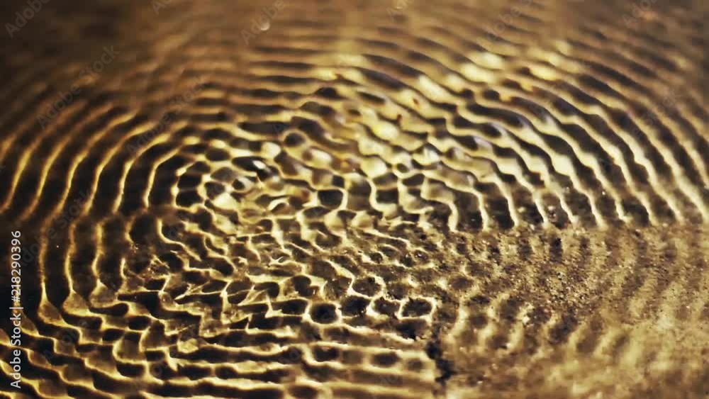Vibrational waves at the surface of the water. Water cymatics