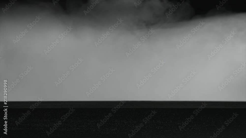 Slow motion smoke/water vapor flowing on top of water against black. For use with visual effects and/or texturing and design. Slow motion smoke/water vapor flowing on top of water against black. For use with visual effects and/or texturing and design.