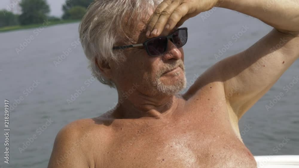 smiling elderly man looking away on a boat smiling elderly man looking away on a boat