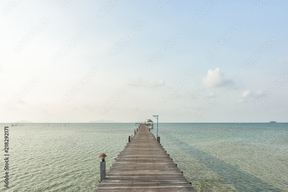 Long wooden bridge go to pavilion on the sea in beautiful tropical island, Thailand.