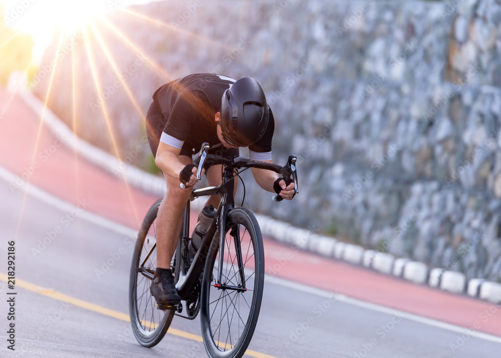 Obraz premium Man cycling on road bike outdoor exercise on an empty road in the morning .