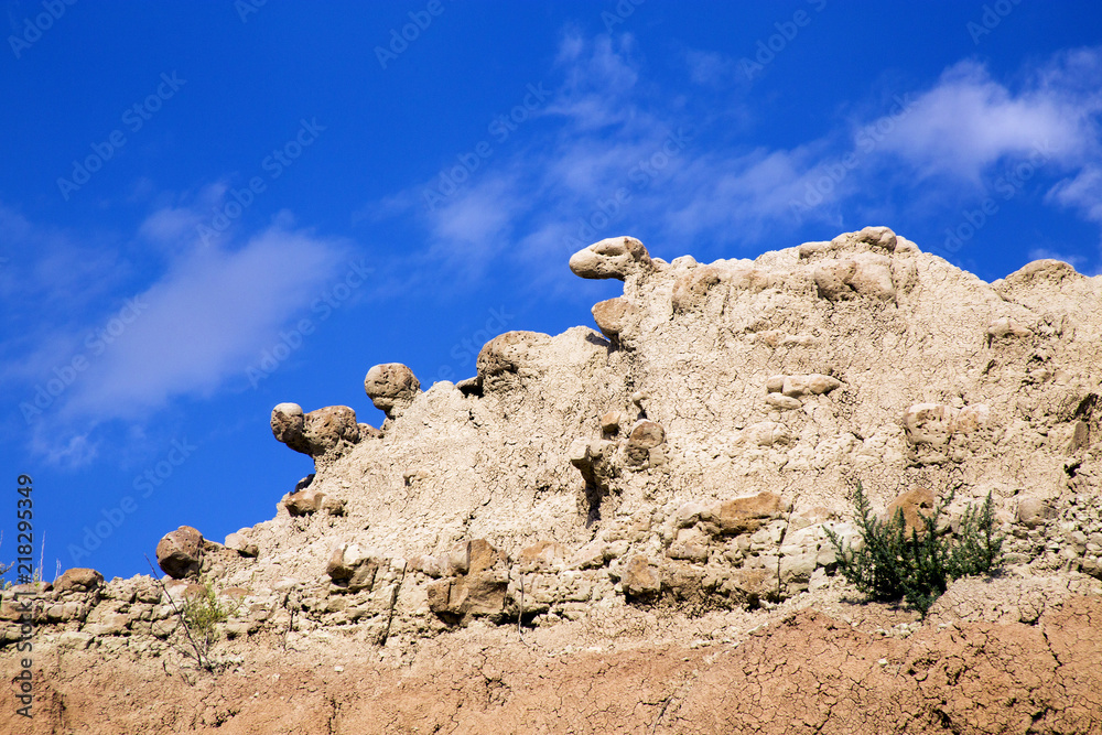 Animal Heads of Rock Peeking Over Cliff in Badlands National Park, South Dakota