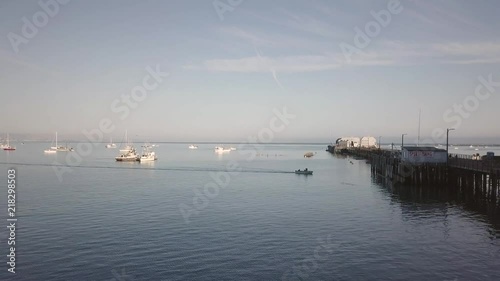 Harford Pier located at Avila Beach. Ocean and boats. Board walk. Restaurant. Fish market. photo